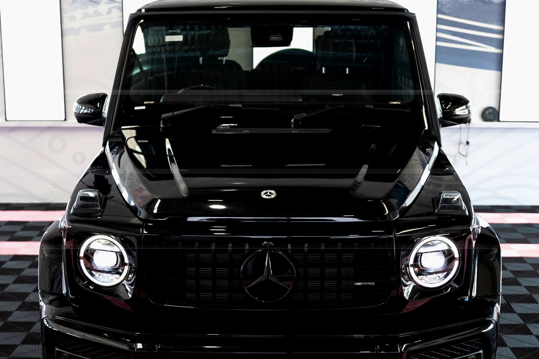 Generated gloss black vehicle ceramic coating finish inside a detailing studio